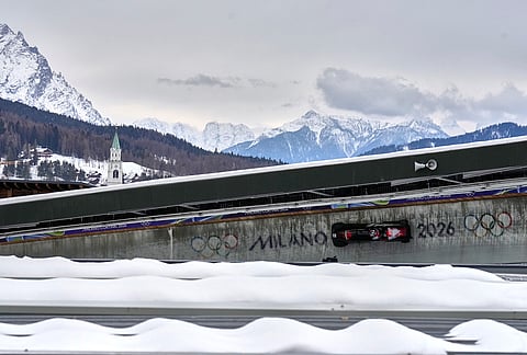 Canada's Taylor Austin, front, and Shaquille Murray-Lawrence slide down the track during a two man bobsled run at the 2026 Winter Olympics, in Cortina d'Ampezzo, Italy.