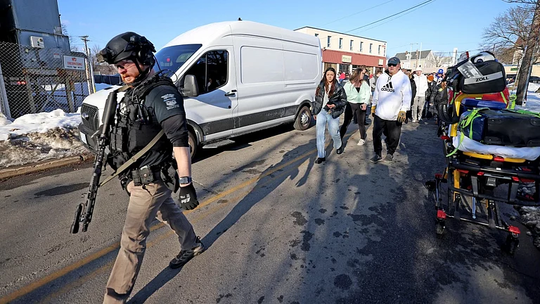 Witnesses follow police outside of the Lynch Arena in Pawtucket, Rhode Island., after a shooting at the ice rink. - AP Photo