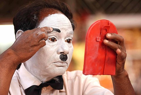 Before stepping into the bustling lanes of Dadar, Afsar Khan carefully applies his makeup, transforming into Charlie Chaplin for another day of performance in Mumbai.