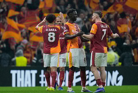 Galatasaray players celebrate after a Champions league play-off first leg soccer match between Galatasaray and Juventus, in Istanbul, Turkey.