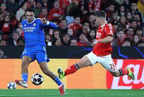 Real Madrid's Trent Alexander-Arnold fights for the ball against Benfica's Samuel Dahl during a Champions League playoff soccer match between SL Benfica and Real Madrid in Lisbon, Portugal.