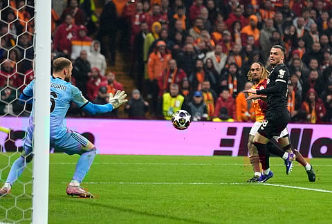 Galatasaray's Sacha Boey, background, scores his side's fifth goal during a Champions league play-off first leg soccer match between Galatasaray and Juventus, in Istanbul, Turkey.