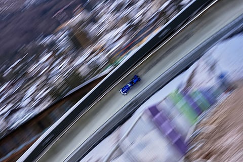 Italy's Simona de Silvestro slides down the track during a two women bobsled training session at the 2026 Winter Olympics, in Cortina d'Ampezzo, Italy.