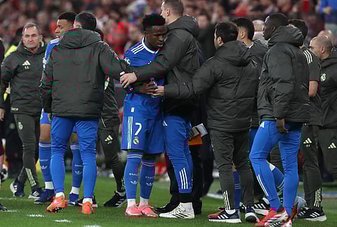 Real Madrid's Vinicius Junior argues after scoring the opening goal during a Champions League playoff soccer match between SL Benfica and Real Madrid in Lisbon, Portugal.