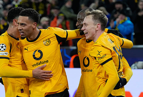 Dortmund's scorers Maximilian Beier and Serhou Guirassy, from right, celebrate during the Champions League Knockout playoff 1st leg soccer match between Borussia Dortmund and Atalanta in Dortmund, Germany.