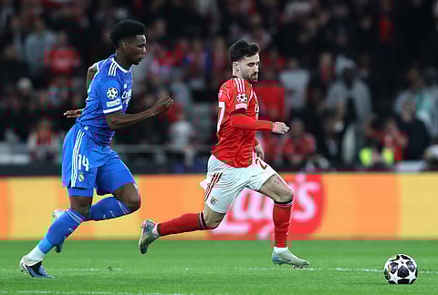 Real Madrid's Aurelien Tchouameni fights for the ball against Benfica's Rafa Silva during a Champions League playoff soccer match between SL Benfica and Real Madrid in Lisbon, Portugal.
