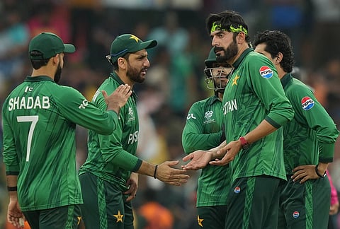 Pakistan's Usman Tariq, right , celebrates with captain Salman Ali Agha, centre, the wicket of Namibia's Ruben Trumpelmann during the T20 World Cup cricket match between Namibia and Pakistan in Colombo, Sri Lanka.