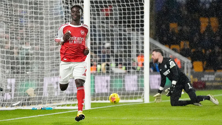 Arsenal's Bukayo Saka celebrates scoring their side's first goal during the Premier League soccer match between Wolverhampton Wanderers and Arsenal in Wolverhampton, England, Wednesday, Feb. 18, 2026. - | Photo: PA/Nick Potts via AP