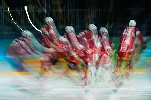 Switzerland players warm up for a men's ice hockey qualification playoff game between Switzerland and Italy at the 2026 Winter Olympics, in Milan, Italy.