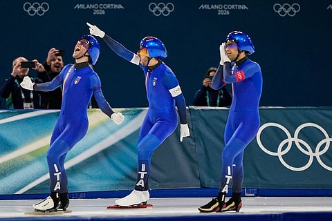 Team Italy with Michele Malfatti, left, Davide Ghiotto, center, and Andrea Giovannini, right, celebrate winning the gold medal in the final of the men's team pursuit speedskating race at the 2026 Winter Olympics, in Milan, Italy.