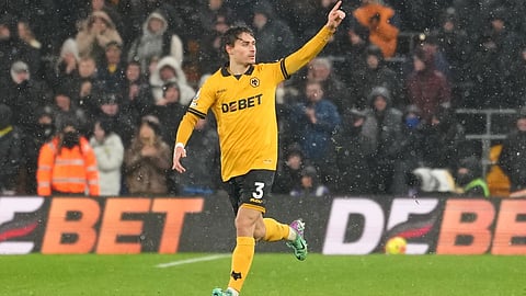Wolverhampton Wanderers' Hugo Bueno celebrates with teammates after scoring his side the first goal during the Premier League soccer match between Wolverhampton Wanderers and Arsenal in Wolverhampton, England, Wednesday, Feb. 18, 2026.