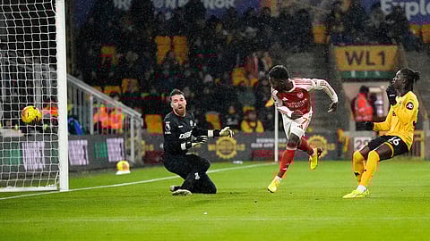 Arsenal's Bukayo Saka scores their first goal during the Premier League soccer match between Wolverhampton Wanderers and Arsenal in Wolverhampton, England, Wednesday, Feb. 18, 2026.