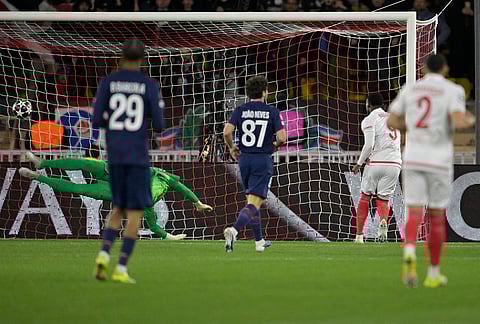 Monaco's Folarin Balogun, second right, scores the opening goal during the first-leg of the Champions League playoff soccer match between Monaco and Paris Saint-Germain in Monaco.
