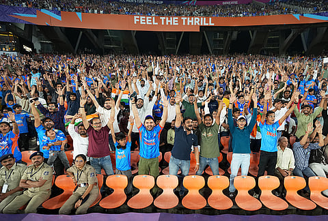 India's fans react to the cameras from the stands during the T20 World Cup cricket match between India and Netherlands in Ahmedabad.