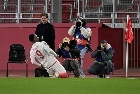 Monaco's Folarin Balogun celebrates after scoring the opening goal during the first-leg of the Champions League playoff soccer match between Monaco and Paris Saint-Germain in Monaco.
