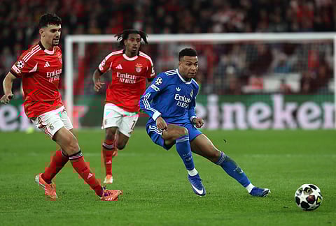 Real Madrid's Kylian Mbappe fights for the ball during a Champions League playoff soccer match soccer match between SL Benfica and Real Madrid in Lisbon, Portugal.