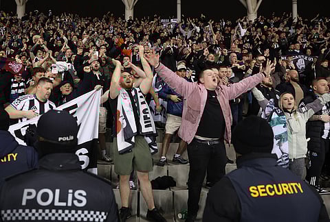 Newcastle's fans cheer their team during the Champions League play-off first leg soccer match between Qarabag and Newcastle in Baku, Azerbaijan.