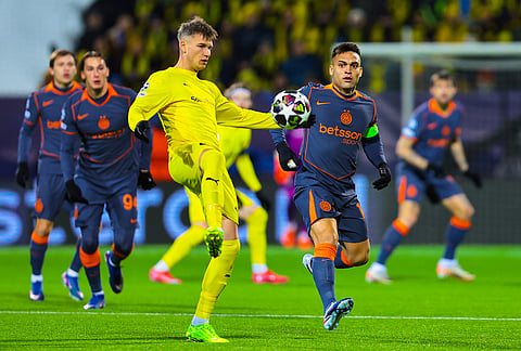 Bodø/Glimt's Fredrik Sjøvold, left, and Inter Milan's Lautaro Martínez vie for the ball during a Champions League soccer match in Bodo, Norway.
