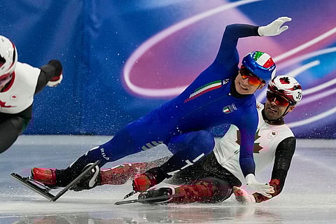 Maxime Laoun of Canada and Pietro Sighel of Italy collide during the short track speed skating men's 500m at the 2026 Winter Olympics, in Milan, Italy, Wednesday, Feb. 18, 2026. ()