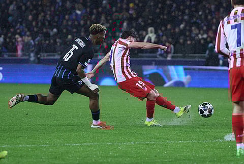 Brugge's Raphael Onyedika, left, and Atletico Madrid's Julian Alvarez challenge for the ball during the Champions League play-off first leg soccer match between Club Brugge and Atletico Madrid, in Bruges, Belgium.
