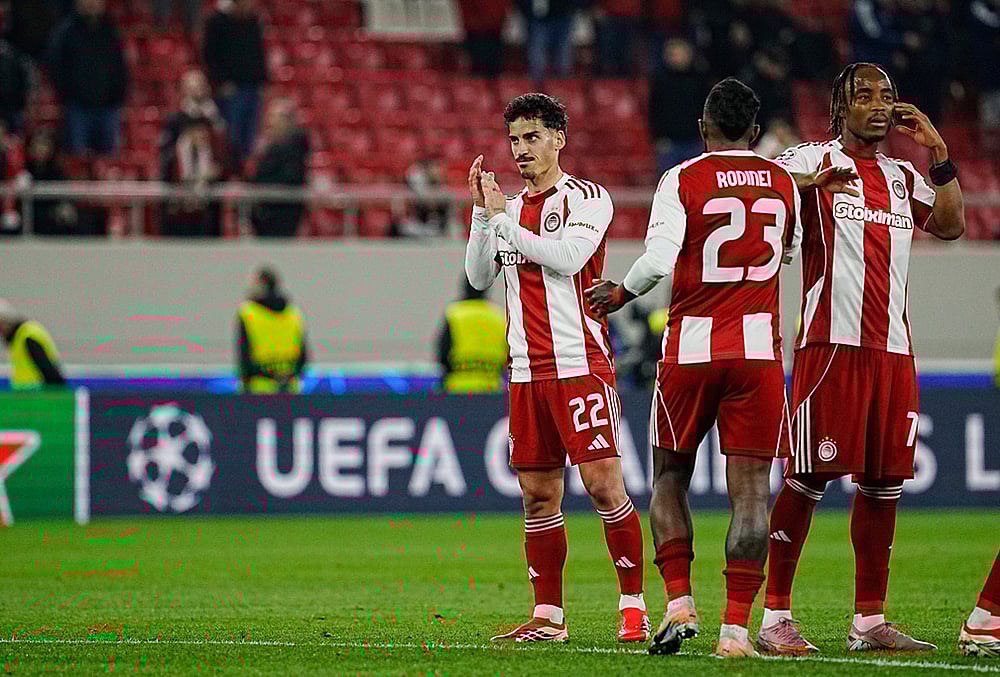 Players of Olympiacos are seen after the end of the Champions League playoff soccer match between Olympiacos and Bayer 04 Leverkusen in Piraeus port, near Athens. - | Photo: AP/Petros Giannakouris