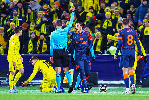 Inter Milan's Francesco Pio Esposito (94) receives a yellow card from referee Daniel Siebert during a Champions League soccer match against Bodø/Glimt in Bodo, Norway.