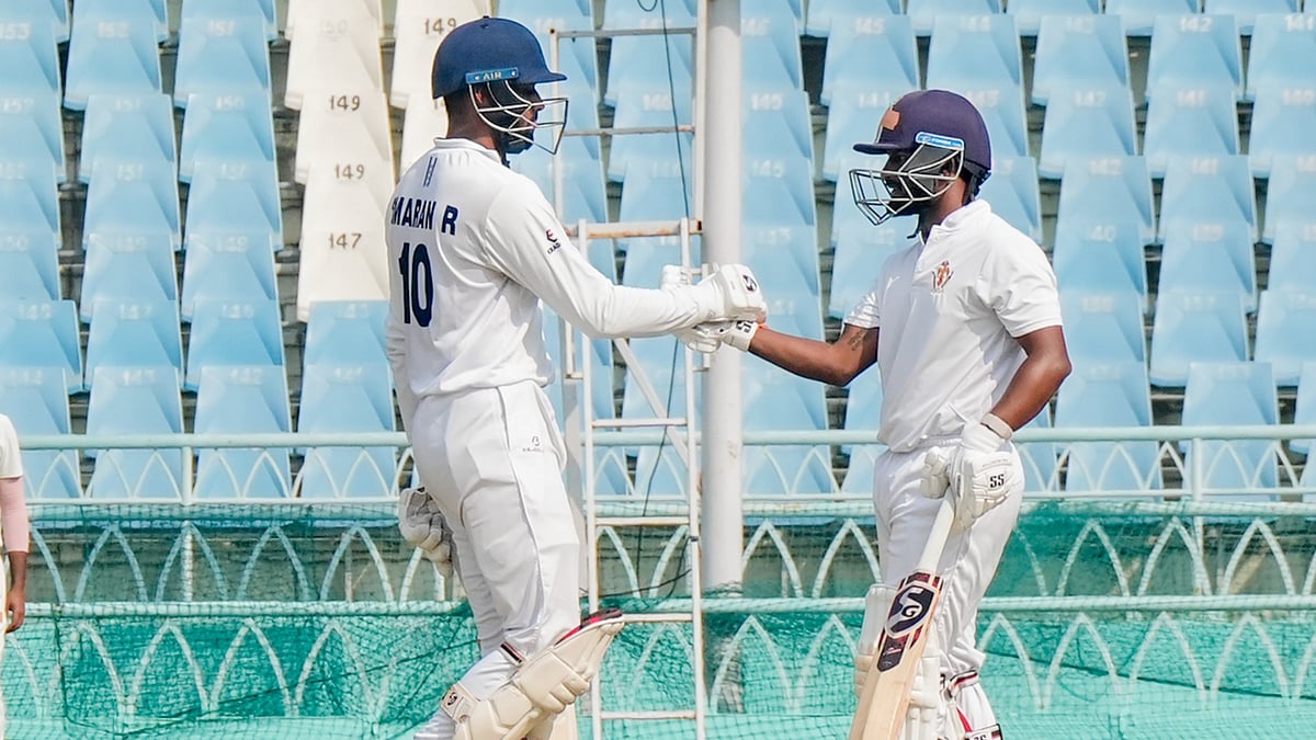 Karnataka's Kruthik Krishna, right, celebrates his half century during day four of the Ranji Trophy semi-final against Uttarakhand, at Ekana Cricket Stadium in Lucknow. - PTI