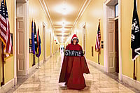 How Language Prepares The Ground For Exploitation | Photo: Imago/Zuma Press Wire : Speaking Up: A woman dressed in the red cloak and white bonnet of The Handmaid’s Tale lobbies Congress to release the Epstein files