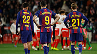 | Photo: AP/Joan Monfort : Barcelona's Frenkie de Jong, Marc Bernal and Robert Lewandowski react as Girona player celebrate after winning a Spanish La Liga soccer match between Girona and Barcelona in Girona, Spain, Monday, Feb. 16, 2026. 