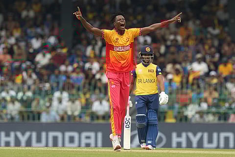 Zimbabwe's Blessing Muzarabani celebrates the wicket of Sri Lanka's Kusal Perera during the T20 World Cup cricket match between Sri Lanka and Zimbabwe in Colombo, Sri Lanka.