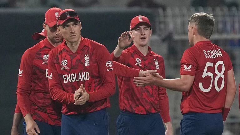 England's Sam Curran, right, celebrates with teammates the wicket of Italy's Marcus Campopiano during the T20 World Cup cricket match between England and Italy in Kolkata, India. - Photo: AP/Bikas Das