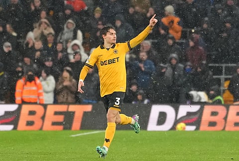 Wolverhampton Wanderers' Hugo Bueno celebrates with teammates after scoring his side the first goal during the Premier League soccer match between Wolverhampton Wanderers and Arsenal in Wolverhampton, England.