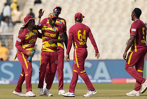 West Indies' Matthew Forde, right, celebrates the wicket of Italy's Gian Piero Meade during the T20 World Cup cricket match between West Indies and Italy in Kolkata.