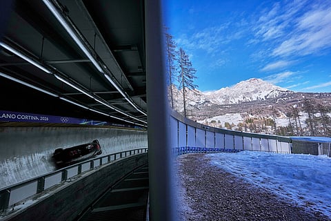 Canada's Bianca Ribi, right, slides down the track during a two women bobsled training session at the 2026 Winter Olympics, in Cortina d'Ampezzo, Italy.
