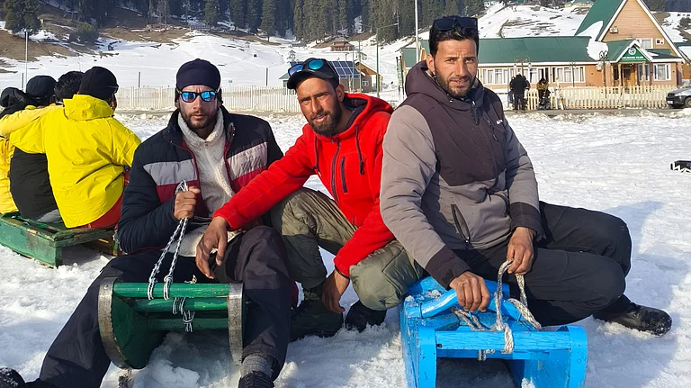 Sledge pullers Altaf Hussain and Muhammad Rafiq carry equipment up slopes that would challenge most tourists. - Special Arrangement