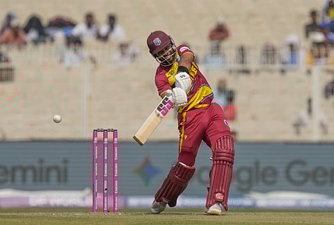 West Indies' captain Shai Hope hits a boundary during the T20 World Cup cricket match between West Indies and Italy in Kolkata.