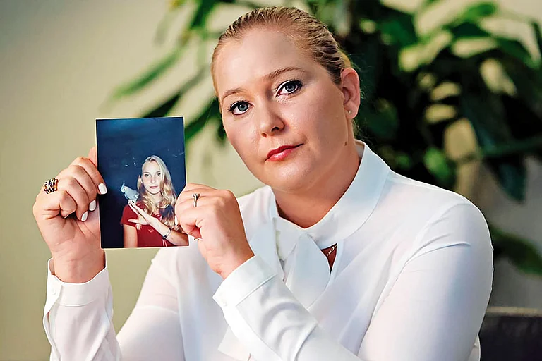 Braveheart: Virginia Giuffre, one of the first women to speak up about being abused by Epstein, holds up a photo of herself as a teenager - Photo: Imago/Zuma Press Wire