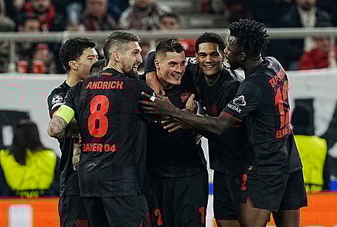 Leverkusen's Patrik Schick, center, celebrates with teammates after scoring against Olympiacos during a Champions League playoff soccer match between Olympiacos and Bayer 04 Leverkusen in Piraeus port, near Athens.