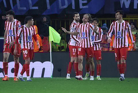 Atletico's players celebrate after Brugge's Joel Ordonez scored the own goal during the Champions League play-off first leg soccer match between Club Brugge and Atletico Madrid, in Bruges, Belgium.
