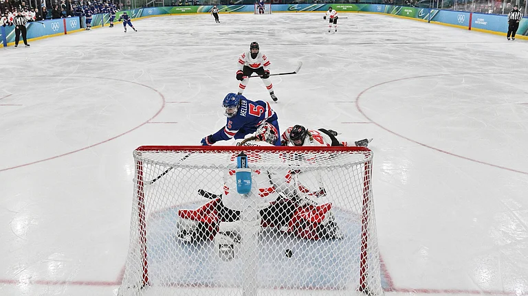 United States' Megan Keller (5) scores the winning goal during the women's ice hockey gold medal game between the United States and Canada at the 2026 Winter Olympics, in Milan, Italy, Thursday, Feb. 19, 2026. - Alexander Nemenov/Pool Photo via AP