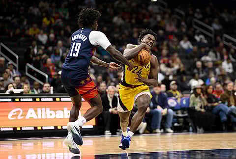 Washington Wizards guard Kadary Richmond (19) battles for the ball against Indiana Pacers guard Kobe Brown (24) during the first half of an NBA basketball game, in Washington.