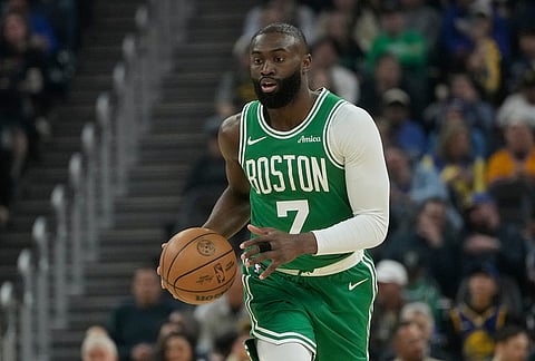 Boston Celtics guard Jaylen Brown (7) brings the ball up the court against the Golden State Warriors during the first half of an NBA basketball game in San Francisco.
