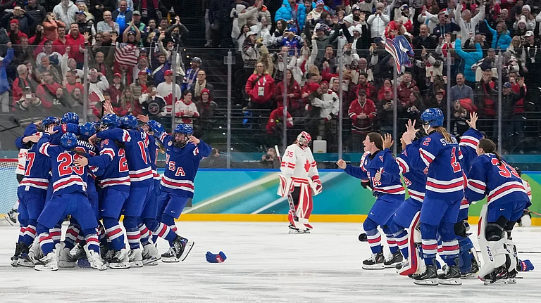 United States players celebrate after a women's ice hockey gold medal game between the United States and Canada at the 2026 Winter Olympics, in Milan, Italy, Thursday, Feb. 19, 2026. - AP Photo/Hassan Ammar