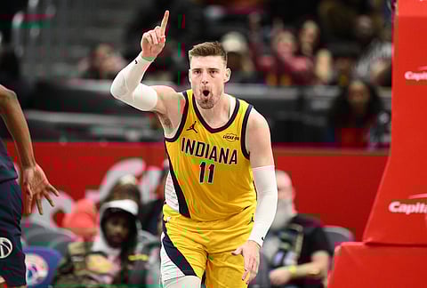 Indiana Pacers center Micah Potter (11) reacts after dunking during the second half of an NBA basketball game against the Washington Wizards, in Washington.