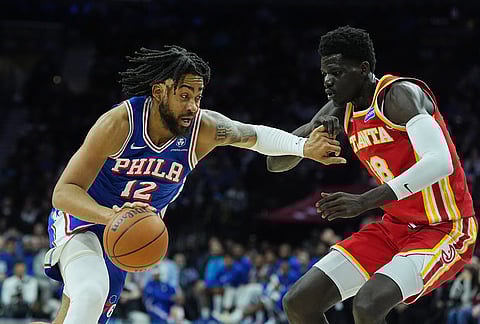 Philadelphia 76ers' Trendon Watford, left, tries to get past Atlanta Hawks' Mouhamed Gueye during the second half of an NBA basketball game in Philadelphia.