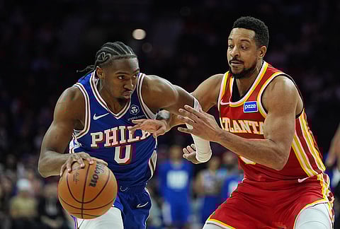 Philadelphia 76ers' Tyrese Maxey, left, tries to get past Atlanta Hawks' CJ McCollum during the second half of an NBA basketball game in Philadelphia.