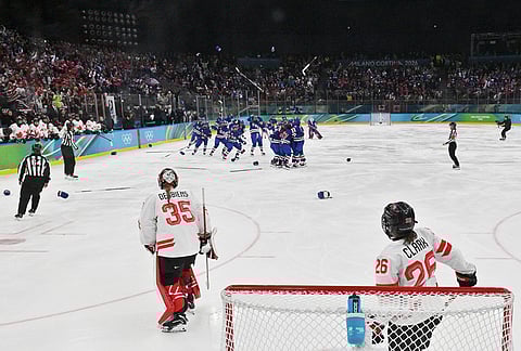 United States' players celebrate after winning the women's ice hockey gold medal game between the United States and Canada at the 2026 Winter Olympics, in Milan, Italy.