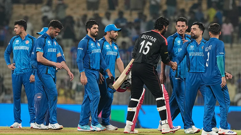 Afghanistan's captain Rashid Khan, second right, shakes hands with Canada's Jaskarandeep Buttar after winning the T20 World Cup cricket match between Afghanistan and Canada in Chennai, India, Thursday, Feb. 19, 2026. - (AP Photo/Mahesh Kumar A.)