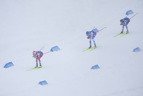 Johannes Lamparter, of Austria, from left, Eero Hirvonen, of Finland, and Ryota Yamamoto, of Japan, compete in the nordic combined team sprint at the 2026 Winter Olympics, in Tesero, Italy.