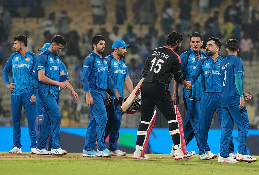 Afghanistan's captain Rashid Khan, second right, shakes hands with Canada's Jaskarandeep Buttar after winning the T20 World Cup cricket match between Afghanistan and Canada in Chennai. - | Photo: AP/Mahesh Kumar A.